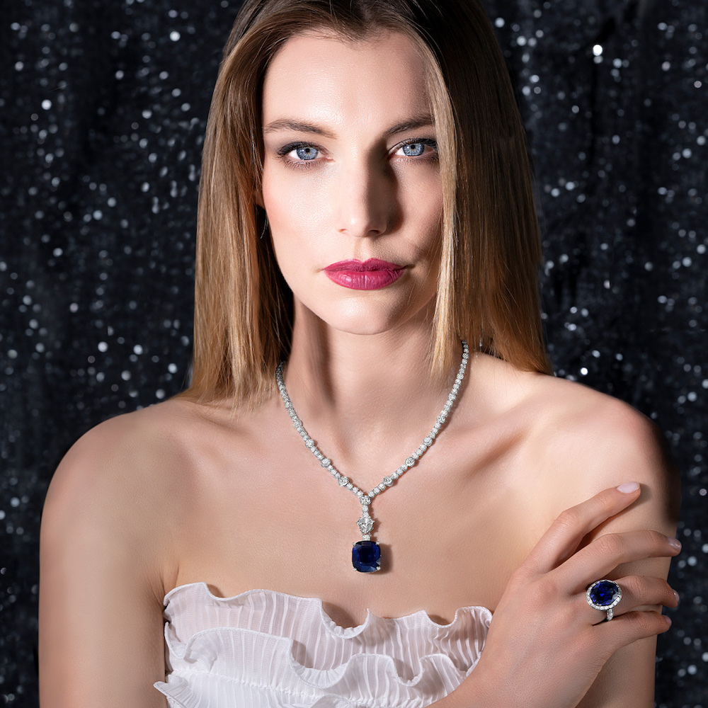 PICCHIOTTI Masterpiece Sapphire pendant necklace featuring a 34.69 cushion cut Sri Lanka vivid Royal Blue sapphire and round diamonds with one kite cut diamond, PICCHIOTTI Masterpiece Sapphire ring featuring a large 34.69 carat oval Sapphire in a halo of baguette diamonds