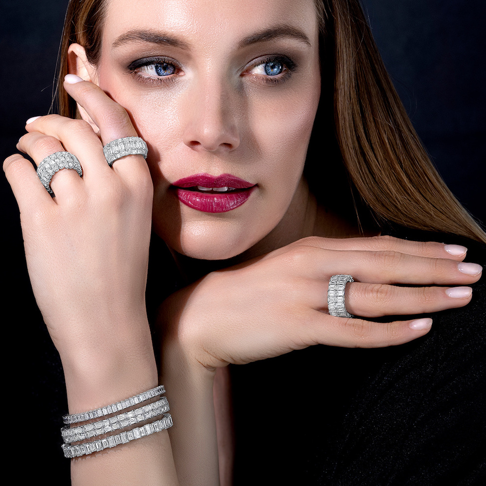 Model wearing Xpandable white diamond rings and three versions of PICCHIOTTI’s Xpandable diamond tennis bracelets. Left to right rings – Xpandable Emerald Cut Lover ring with round diamonds, Xpandable Emerald Cut Lover ring with baguette diamonds, Xpandable Emerald Cut Lover Double Row anniversary band. Bracelets top to bottom – Xpandable Emerald Cut Lover diamond bracelet, Xpandable Emerald Cut Lover double row diamond bracelet, Xpandable Emerald Cut Lover bracelet with alternating sizes of diamonds